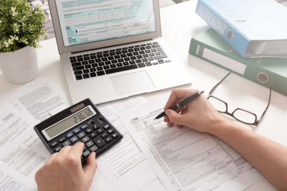 US Individual income tax return. Accountant working with US tax forms.