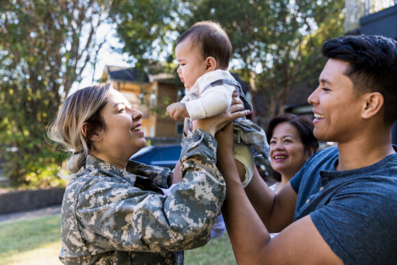 Soldier embracing her family after coming back from service.