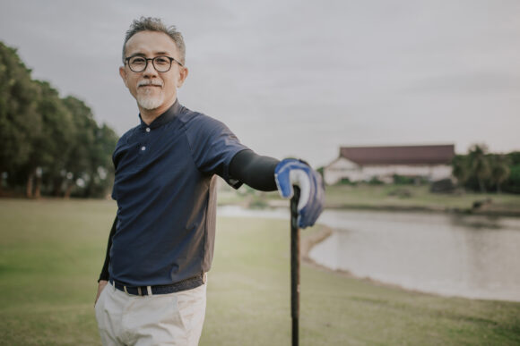 Middle aged man on a golf course.