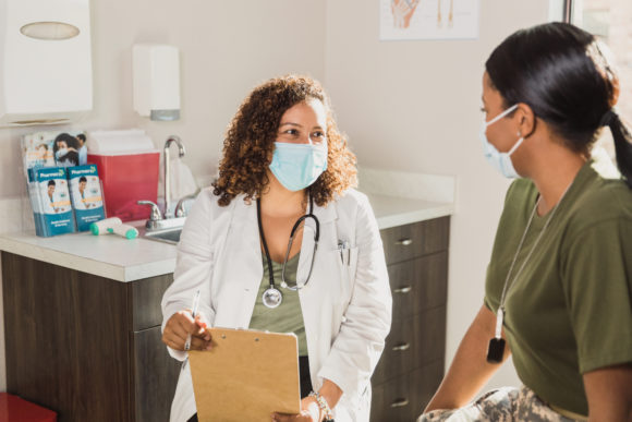 Doctor speaks with soldier